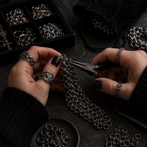 Close-up craftsmanship detail of chainmail-inspired gothic accessories. Close-up craftsmanship detail of chainmail-inspired gothic accessories.