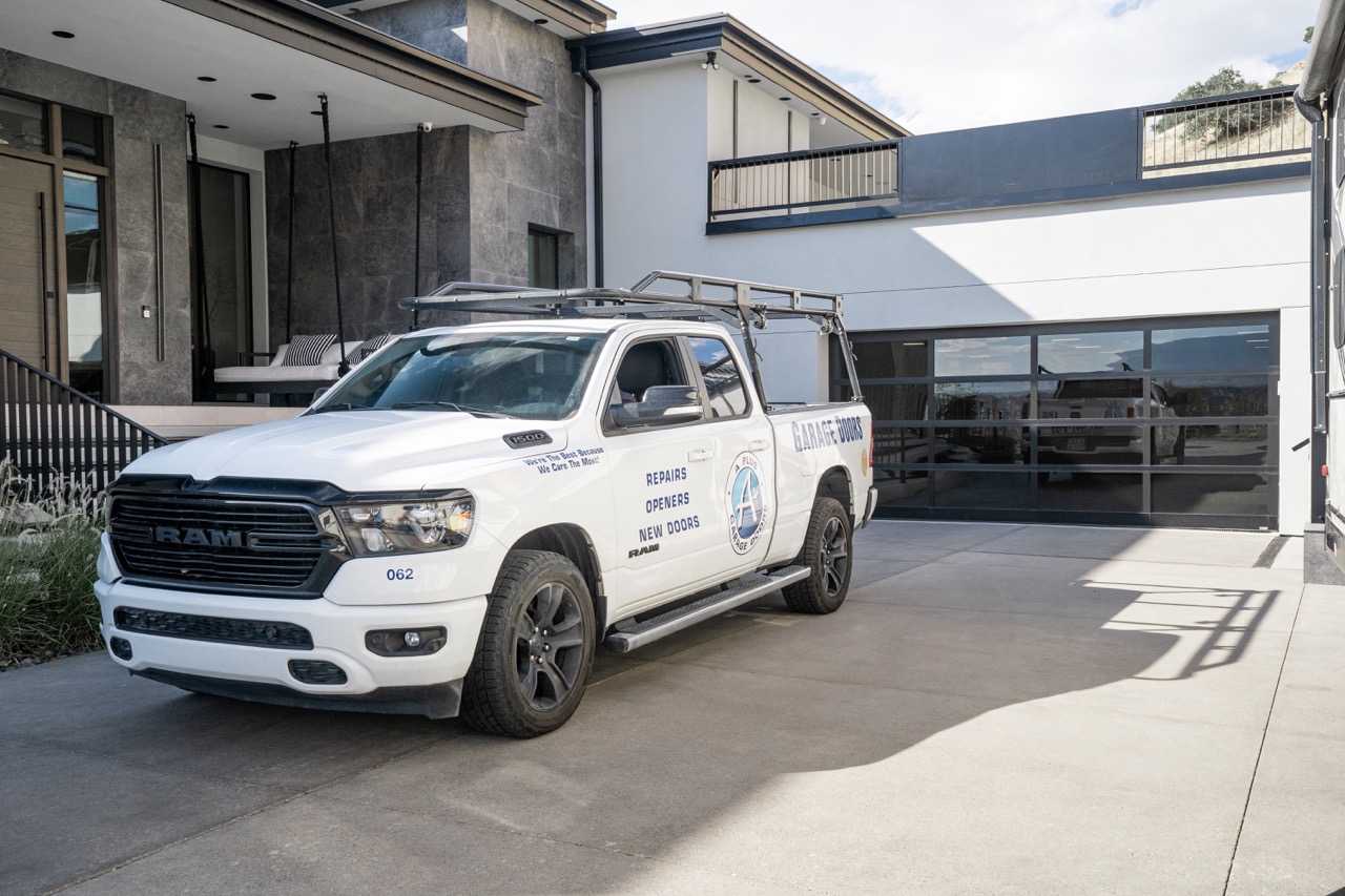 A+ Truck Outside a Logan Utah house with a Glass Garage Door - Double | Professional Garage Door Repair | Best New Garage Door Installation