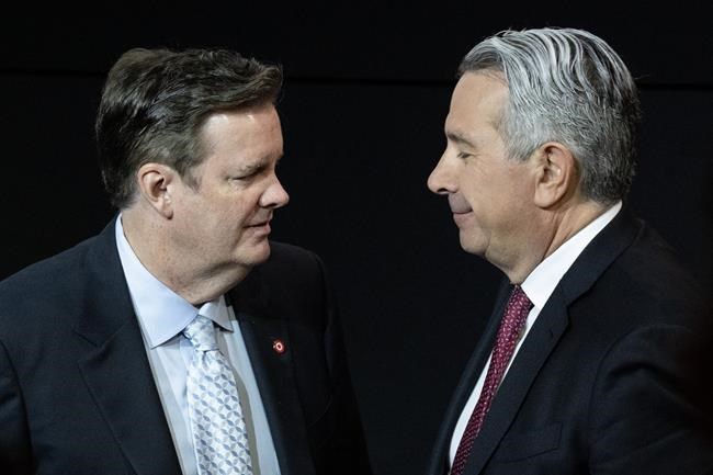 Edward Rogers, left, talks with Tony Staffieri at the Rogers Communications annual general meeting in Toronto on Wednesday, April 26, 2023. Two members of the Rogers family who had opposed their brother Edward's plan to replace former chief executive Joe Natale with his successor Staffieri have announced their retirement from the company's board of directors.THE CANADIAN PRESS/Chris Young