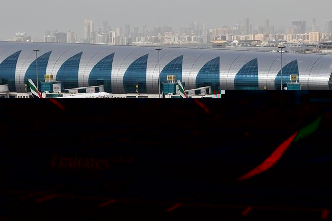 FILE - An Emirates plane taxis to a gate at Dubai International Airport at Dubai International Airport in Dubai, United Arab Emirates, March 22, 2017. (AP Photo/Adam Schreck, File)