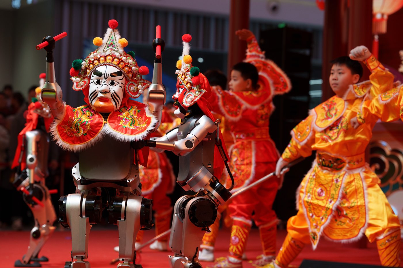 FILE - Humanoid robot performers dressed in traditional costume join dancers in a performance during Lunar New Year celebrations in Beijing, Thursday, Feb. 19, 2026. (AP Photo/Vincent Thian, File)