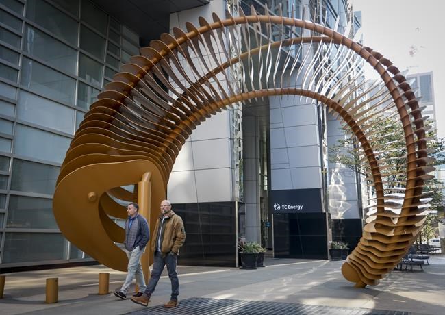 Pedestrians walk past a sculpture outside the TC Energy head office in downtown Calgary, Alta., Friday, Sept. 16, 2022.THE CANADIAN PRESS/Jeff McIntosh