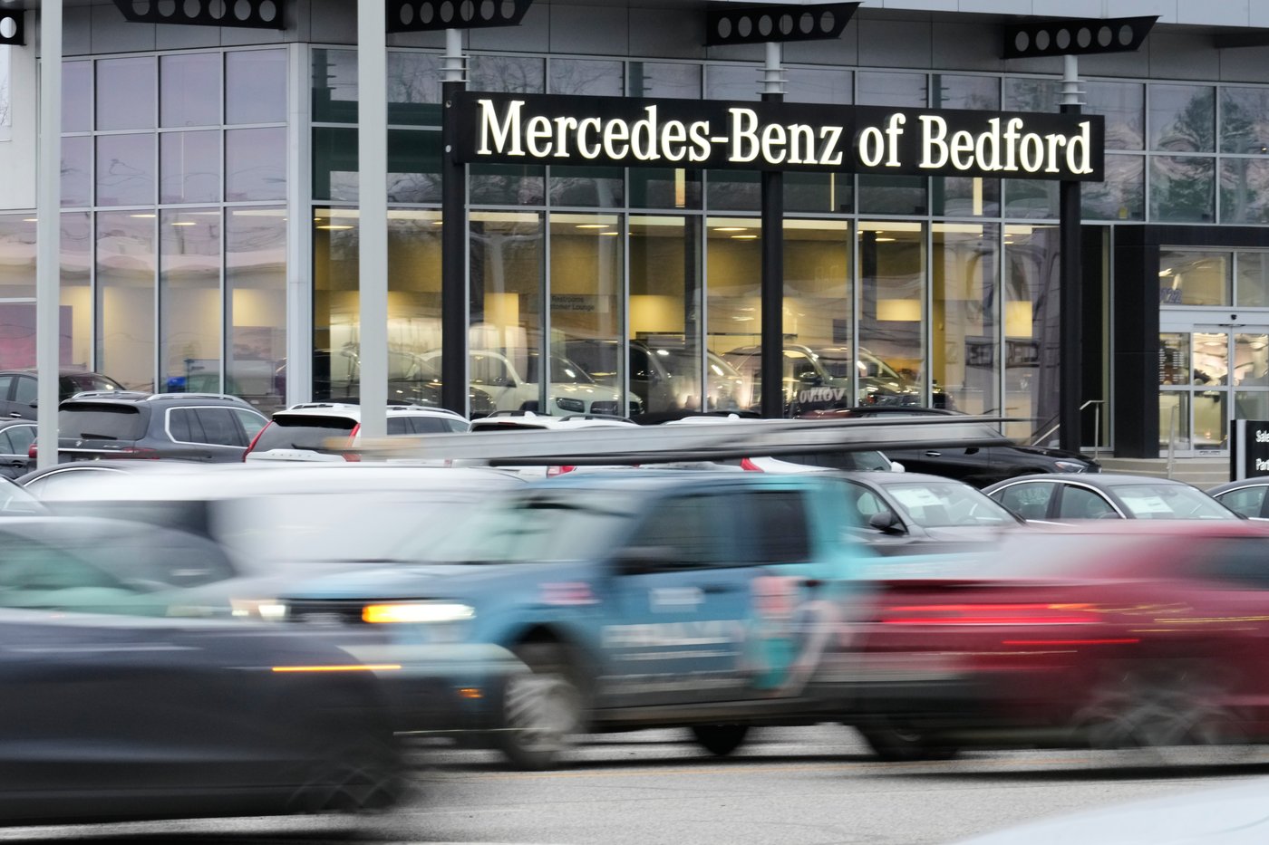Cars drive by a Mercedes-Benz dealership on the Bedford Automile in Bedford, Ohio, Friday, Feb. 20, 2026. (AP Photo/Sue Ogrocki)
