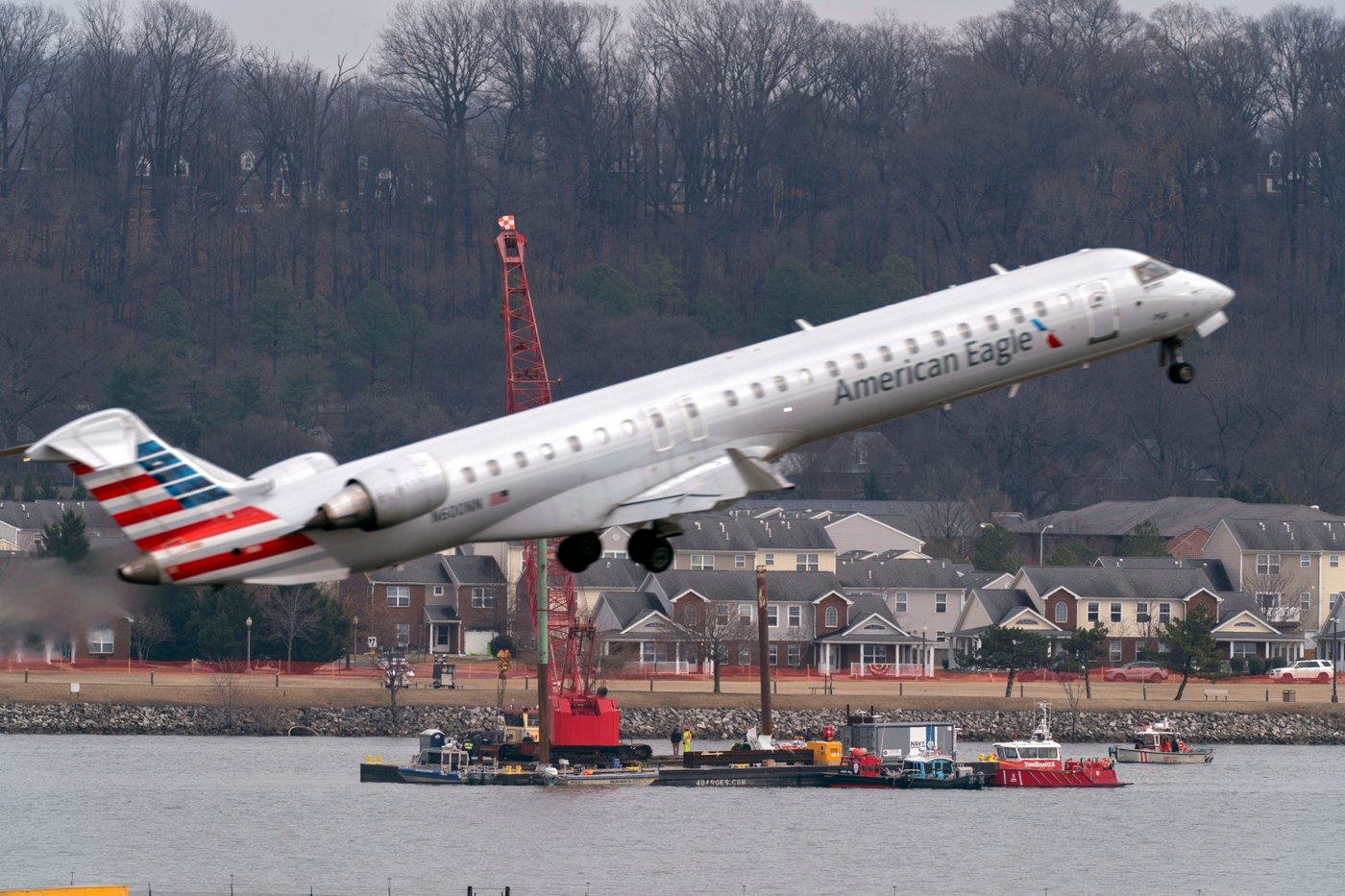 FILE - Salvage crews work on recovering wreckage near the site in the Potomac River of a mid-air collision between an American Airlines jet and a Black Hawk helicopter at Ronald Reagan Washington National Airport, Feb. 6, 2025, in Arlington, Va. (AP Photo/Jose Luis Magana, File)