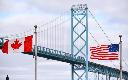 Canadian and American flags fly near the Ambassador Bridge at the Canada/USA border crossing in Windsor, Ont. on Saturday, March 21, 2020. THE CANADIAN PRESS/Rob Gurdebeke