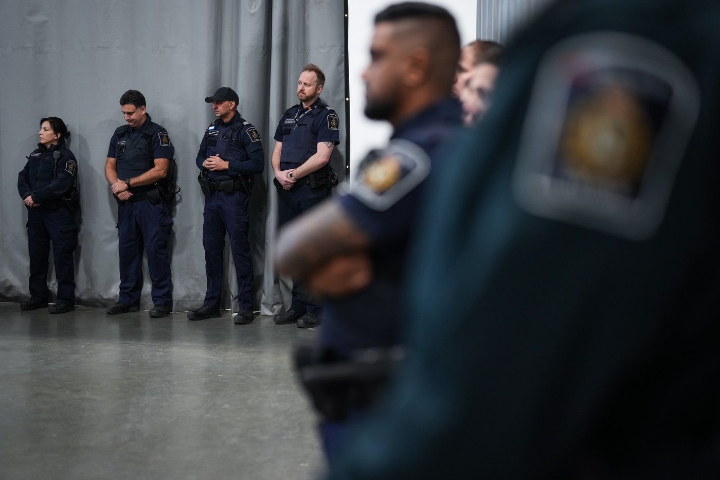 Canada Border Services Agency officers listen during an announcement about a seizure of opium, in Tsawwassen, B.C., Friday, Dec. 16, 2022. THE CANADIAN PRESS/Darryl Dyck