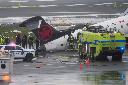 Firefighters and investigators examine the site, Monday, March 23, 2026, where an Air Canada jet came to rest after colliding with a Port Authority firetruck at LaGuardia Airport, after landing Sunday night in New York. (AP Photo/Seth Wenig)