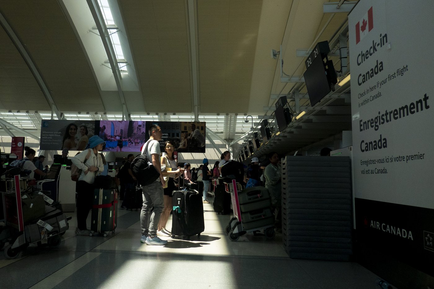 Passengers wait to check in at Toronto's Pearson International Airport on Thursday July 3, 2025. THE CANADIAN PRESS/Chris Young