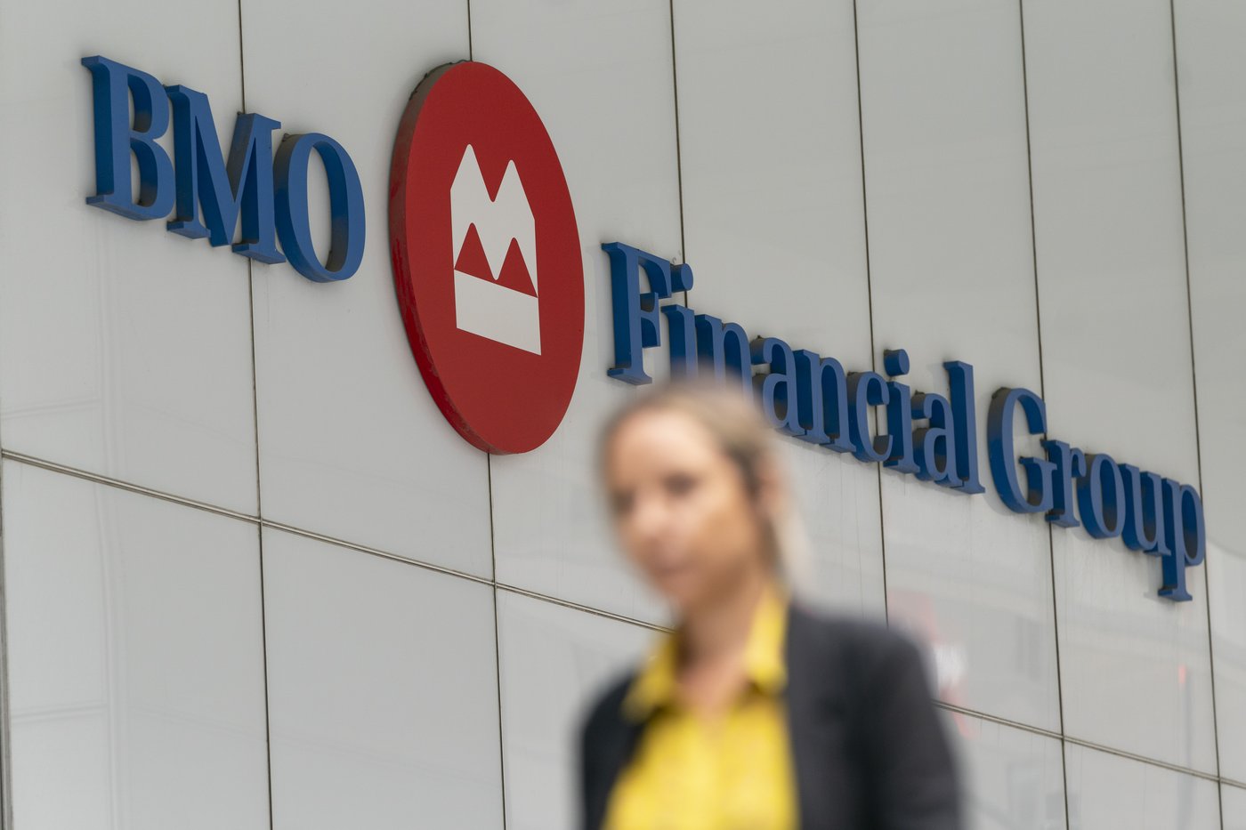 A person makes their way past the Bank of Montreal (BMO) building in the Financial District of Toronto, on Monday, Aug. 14, 2023. THE CANADIAN PRESS/Spencer Colby