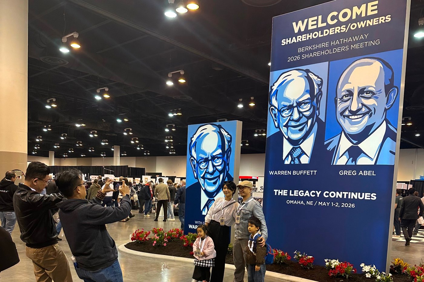 Shareholders line up to take pictures with depictions of Berkshire Hathaway's new CEO Greg Abel and Chairman Warren Buffett on Friday, May 1, 2026 in Omaha, Neb. (AP Photo/Josh Funk)