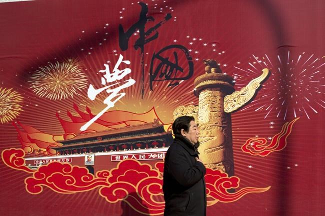 FILE - A man walks past the words "China Dream" on a street in Beijing on March 5, 2015. Chinese President Xi Jinping calls for the China Dream "great rejuvenation of the Chinese nation" based on reviving the ruling party's role as an economic, social and cultural leader in a throwback to what he sees as a golden age after the 1949 revolution. (AP Photo/Ng Han Guan, File)