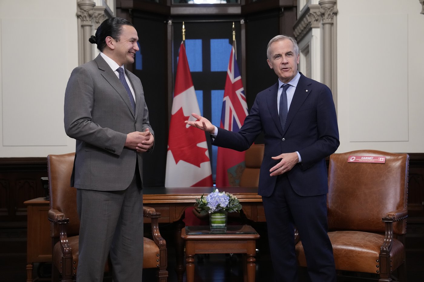 Prime Minister Mark Carney, right, meets with Manitoba Premier Wab Kinew on Parliament Hill in Ottawa, Tuesday, April 14, 2026. THE CANADIAN PRESS/Adrian Wyld
