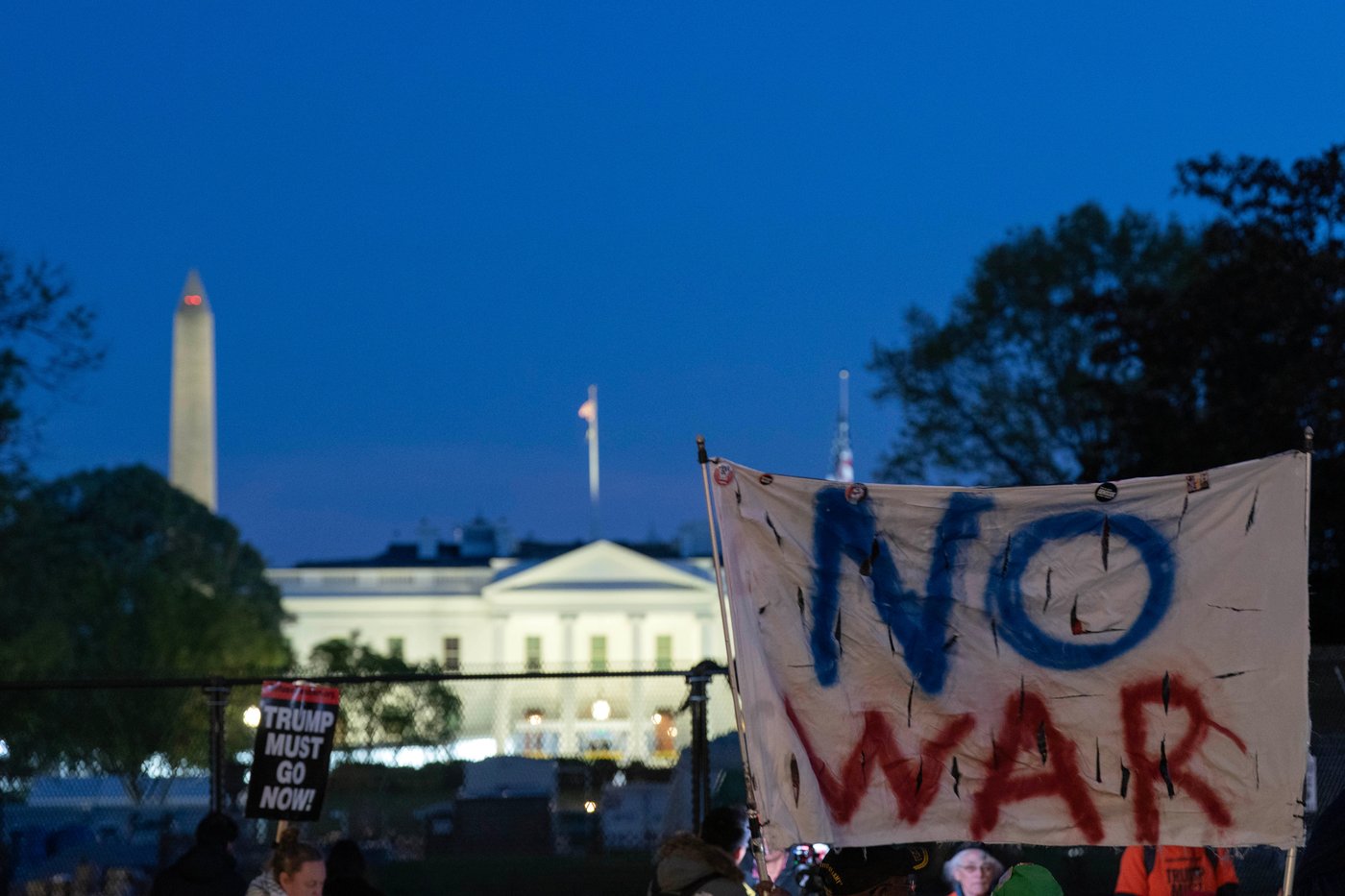 Activists protest at Lafayette Park near the White House in Washington, Tuesday evening, April 7, 2026. (AP Photo/Jose Luis Magana)