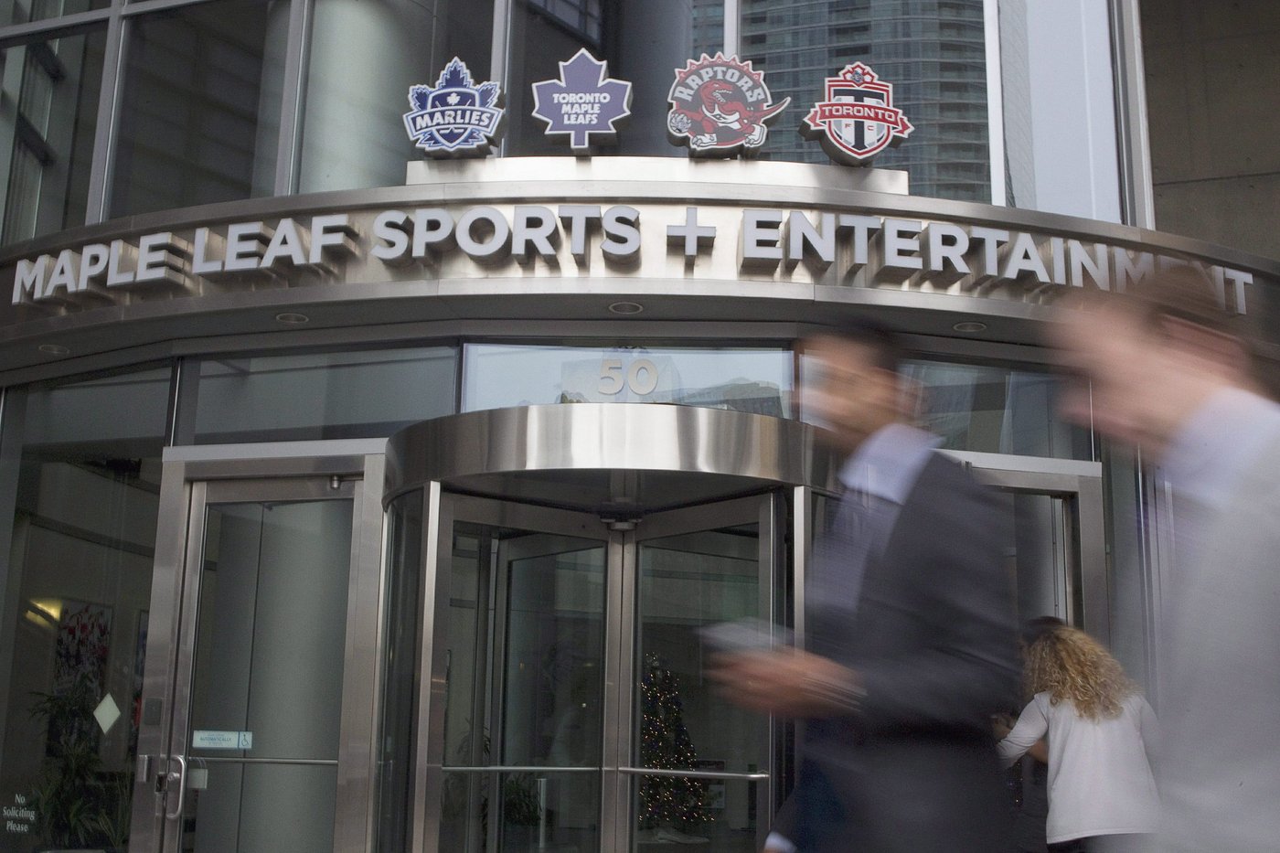 Pedestrian pass the Maple Leafs Sports and Entertainment headquarters in Toronto on Friday Dec. 9, 2011. THE CANADIAN PRESS/Chris Young