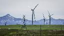 Power transmission lines and wind turbines as seen with the Rocky Mountains in the background near Pincher Creek, Alta., Thursday, June 6, 2024. THE CANADIAN PRESS/Jeff McIntosh