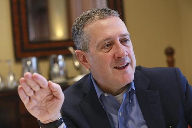 FILE - In this Nov. 19, 2019, photo James Bullard, president of the St. Louis Federal Reserve Bank, gestures during an interview in Richmond, Va. The Federal Reserve may have to raise its benchmark interest rate much higher than many people expect to get inflation under control, Bullard said Thursday, Nov. 17, 2022. (AP Photo/Steve Helber, File)