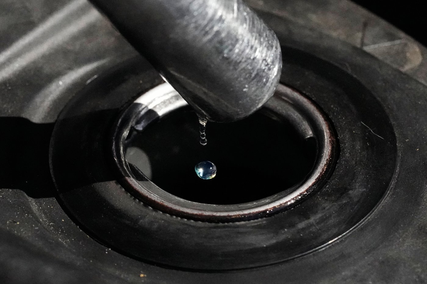 FILE - Gasoline drops from the nozzle of a fuel pump as it fills a motorcycle as prices continue to rise at a gasoline station in Quezon City, Philippines on March 19, 2026. (AP Photo/Aaron Favila, File)