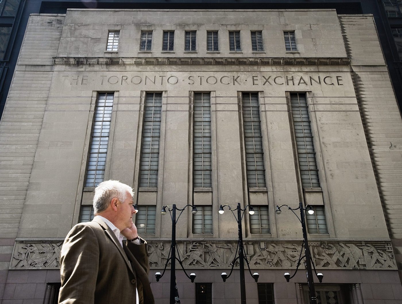 A man walks past a building in Toronto that used to house the Toronto Stock Exchange on Thursday, August 18 2011. THE CANADIAN PRESS/Aaron Vincent Elkaim