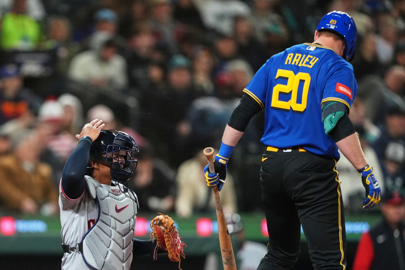 FILE - Cleveland Guardians catcher Bo Naylor challenges a call during an at-bat by Seattle Mariners' Luke Raley during the fourth inning of a baseball game, Friday, March 27, 2026, in Seattle. (AP Photo/Lindsey Wasson, filr)