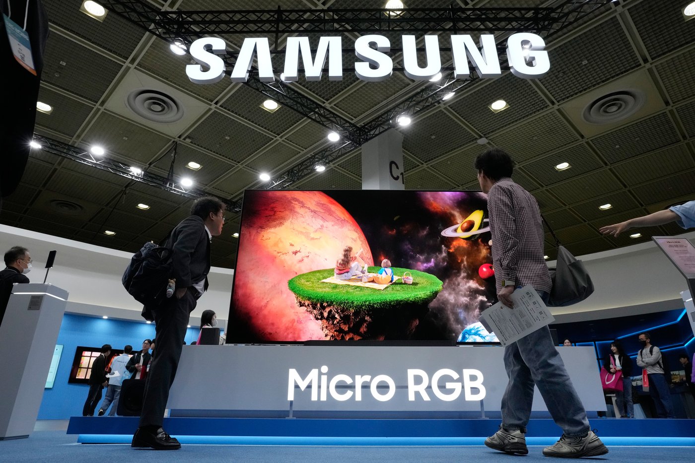 Visitors watch a Samsung Electronics' Micro RGB TV at its booth during the World IT Show in Seoul, South Korea, Wednesday, April 22, 2026. (AP Photo/Ahn Young-joon)
