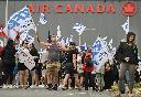 People protest outside Air Canada headquarters in Montreal, Sunday, Aug. 17, 2025, after the federal government intervened in the labour dispute between the airline and the union representing its flight attendants, ordering binding arbitration and operations to resume. THE CANADIAN PRESS/Graham Hughes
