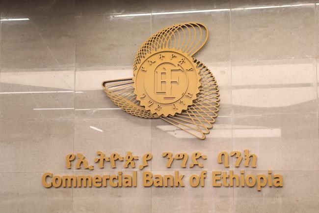 Commercial Bank of Ethiopia signage seen outside a branch in Addis Ababa, Ethiopia Tuesday, March. 26, 2024. Ethiopia's biggest bank says it has recouped nearly 80% of the cash it lost during a "system glitch" that allowed customers to take out more money than they had in their accounts. (AP Photo/Amir Aman Kiyaro)