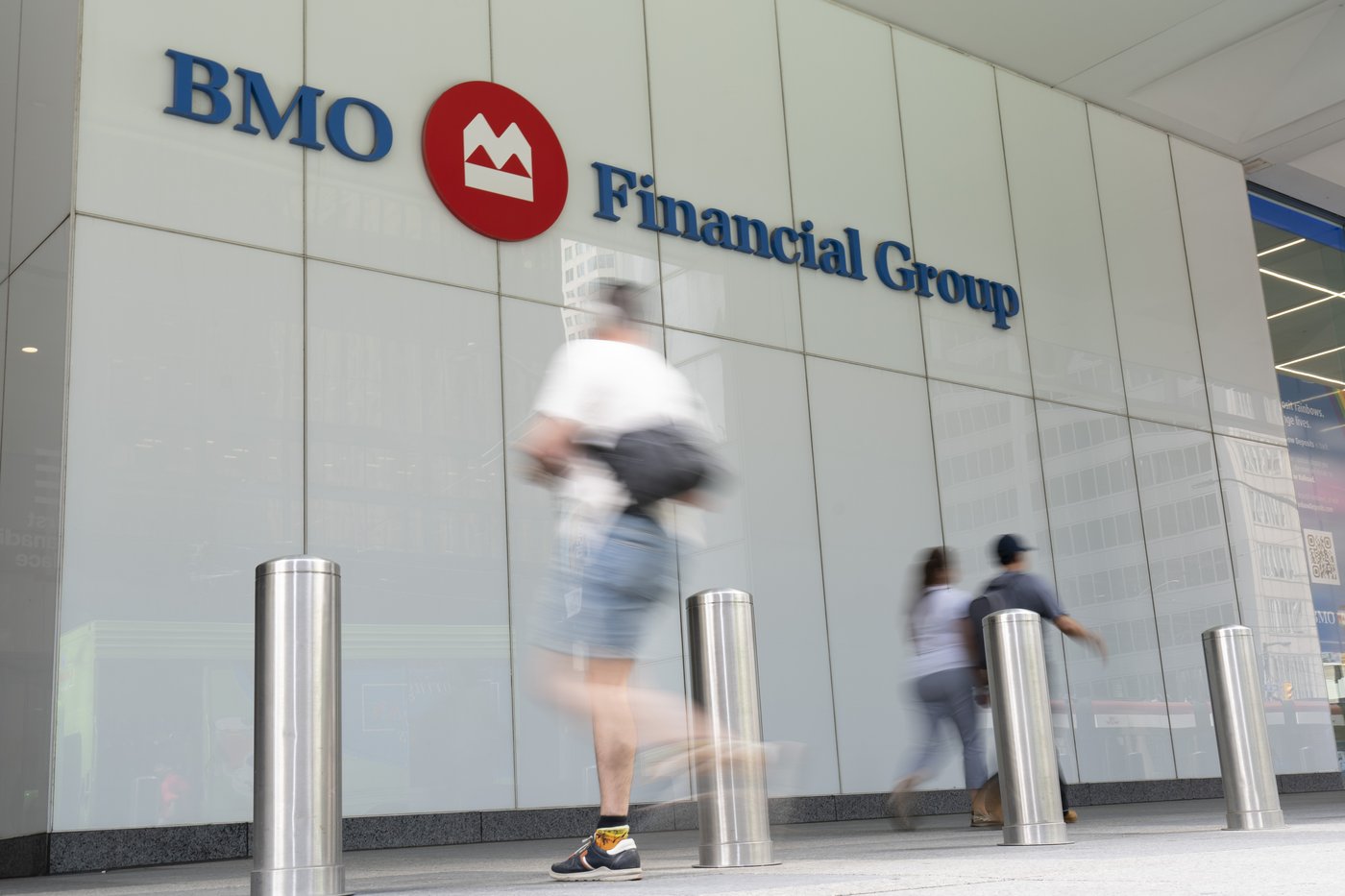 People make their way past the Bank of Montreal building in the Financial District of Toronto, Monday, Aug. 14, 2023. THE CANADIAN PRESS/Spencer Colby