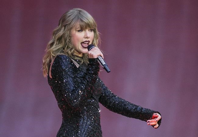 FILE - Singer Taylor Swift performs on stage in a concert at Wembley Stadium on June 22, 2018, in London. On the heels of a messy ticket roll out for Swift’s first tour in years, fans are angry; they’re also energized against Ticketmaster. While researchers agree that there’s no way to tell how long the energy could last, the outrage shows a way for young people to become more politically engaged through fan culture. (Photo by Joel C Ryan/Invision/AP, File)