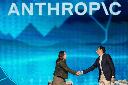 Anthropic co-founder and President Daniela Amodei, left, shakes hands with Snowflake CEO Sridhar Ramaswamy during the keynote presentaton at Snowflake Summit 26 Monday, June 1, 2026, in San Francisco. (AP Photo/Jeff Chiu)