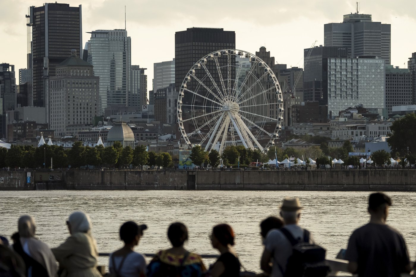 People watch the Montreal skyline on Thursday, Aug. 14, 2025. THE CANADIAN PRESS/Christopher Katsarov