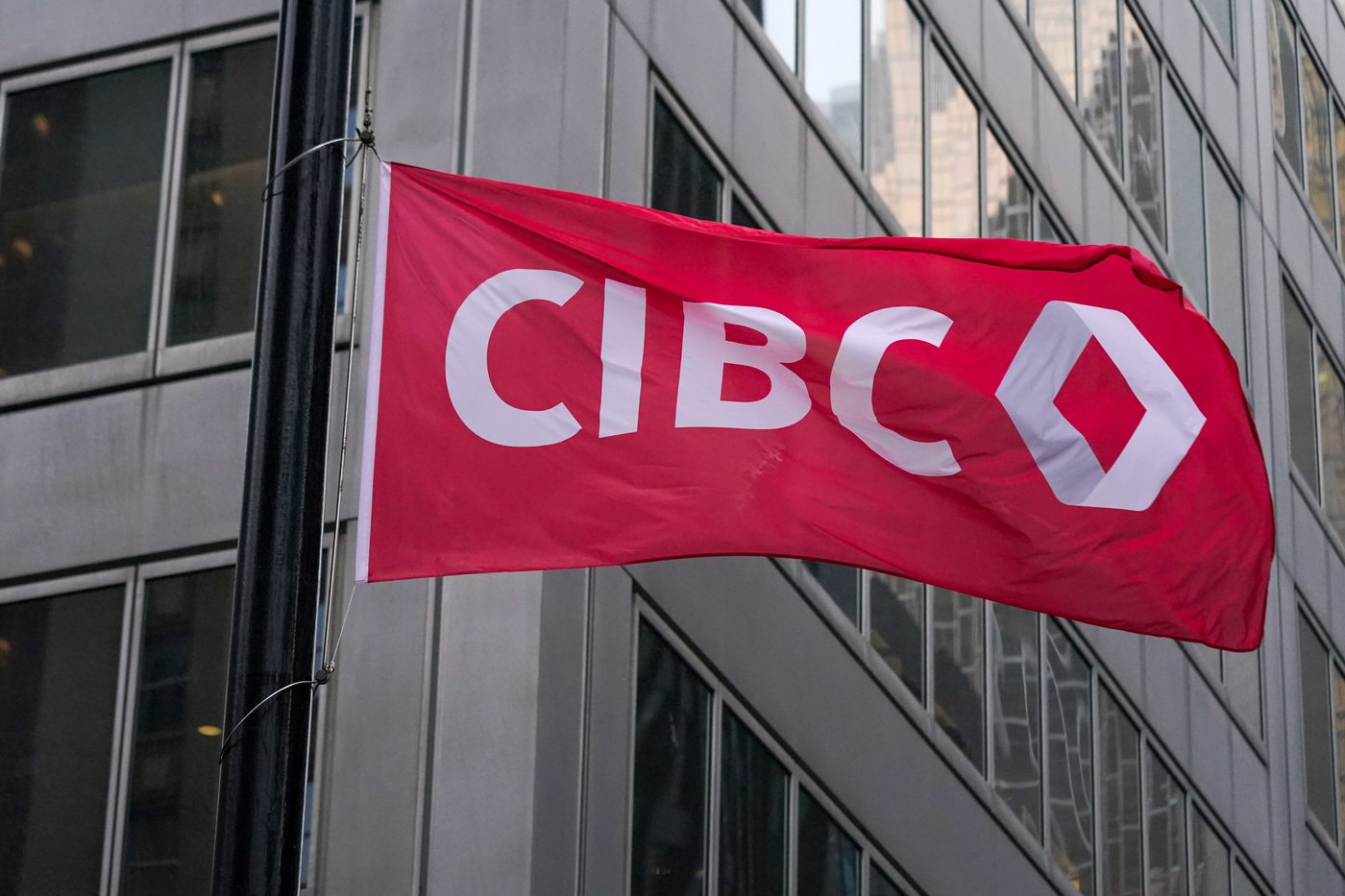 The new CIBC logo displayed on a flag in front of its headquarters in Toronto on Monday, Oct. 25, 2021. THE CANADIAN PRESS/Evan Buhler