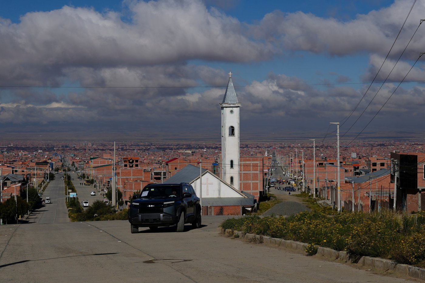 Simón Huanca drives his electric vehicle through the streets of El Alto, Bolivia, Friday, April 24, 2026. (AP Photo/Juan Karita)