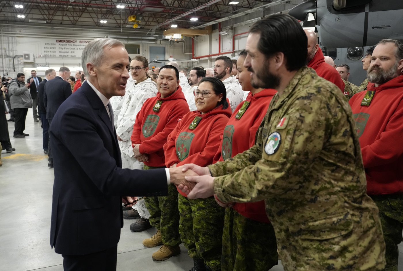 Prime Minister Mark Carney shakes hands with members of the Canadian Forces following an announcement to defend and transform Canada's Northern and Arctic regions in Yellowknife, N.W.T., Thursday, March 12, 2026. THE CANADIAN PRESS/Adrian Wyld