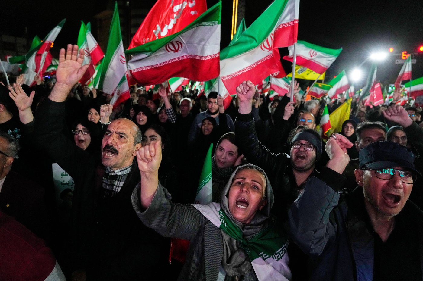Pro-government supporters chant slogans and wave Iranian flags during a rally, in a square in western Tehran, Iran, Wednesday, March 25, 2026. (AP Photo/Vahid Salemi)