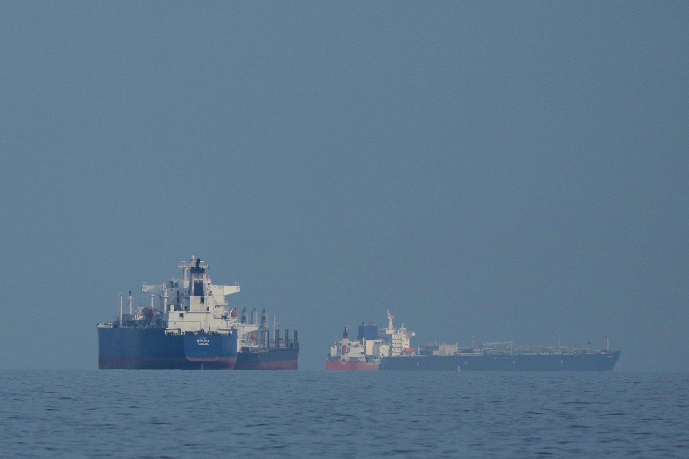 Oil tankers and cargo ships line up in the Strait of Hormuz as seen from Khor Fakkan, United Arab Emirates, Wednesday, March 11, 2026. (AP Photo/Altaf Qadri)