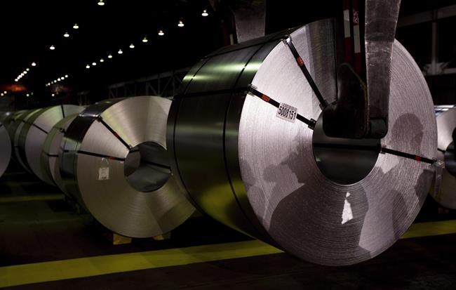 Shadows of workers are reflected on rolls of coated steel at Stelco in Hamilton, Ont. in a Friday, June 29, 2018 file photo. THE CANADIAN PRESS/Peter Power