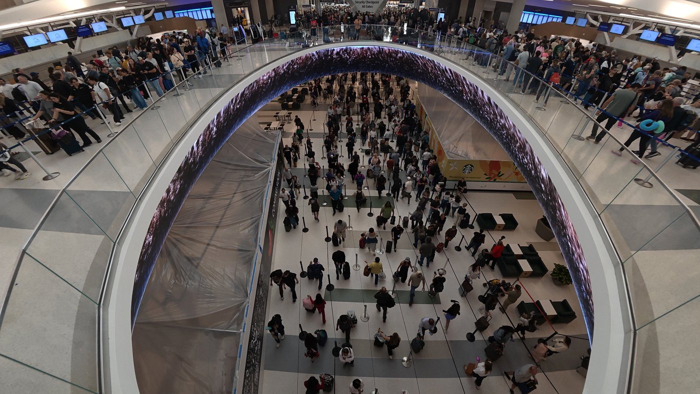 Travelers line up at a TSA checkpoint at George Bush Intercontinental Airport in Houston, Thursday, March 26, 2026. (AP Photo/Lekan Oyekanmi)