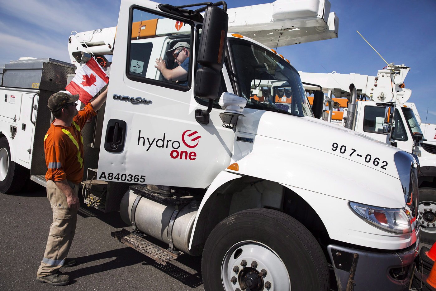 Hydro One workers at the Husky Travel Centre in Niagara-on-the-Lake, Ont. Monday, Sept. 11, 2017. THE CANADIAN PRESS/Tara Walton