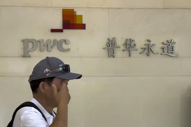 A man walks by the audit firm PricewaterhouseCoopers (PWC) office, at the Fortune Financial Center in Beijing on Tuesday, Aug. 27, 2024. (AP Photo/Andy Wong)