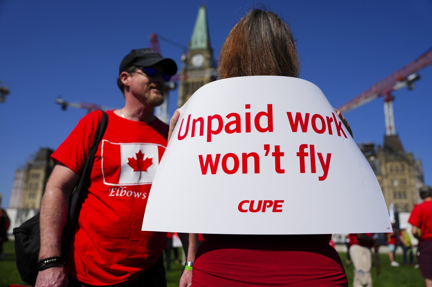 Unionized employees and supporters take part in a rally for Air Canada flight attendants on Parliament Hill in Ottawa, on Tuesday, Sept. 16, 2025. THE CANADIAN PRESS/Sean Kilpatrick