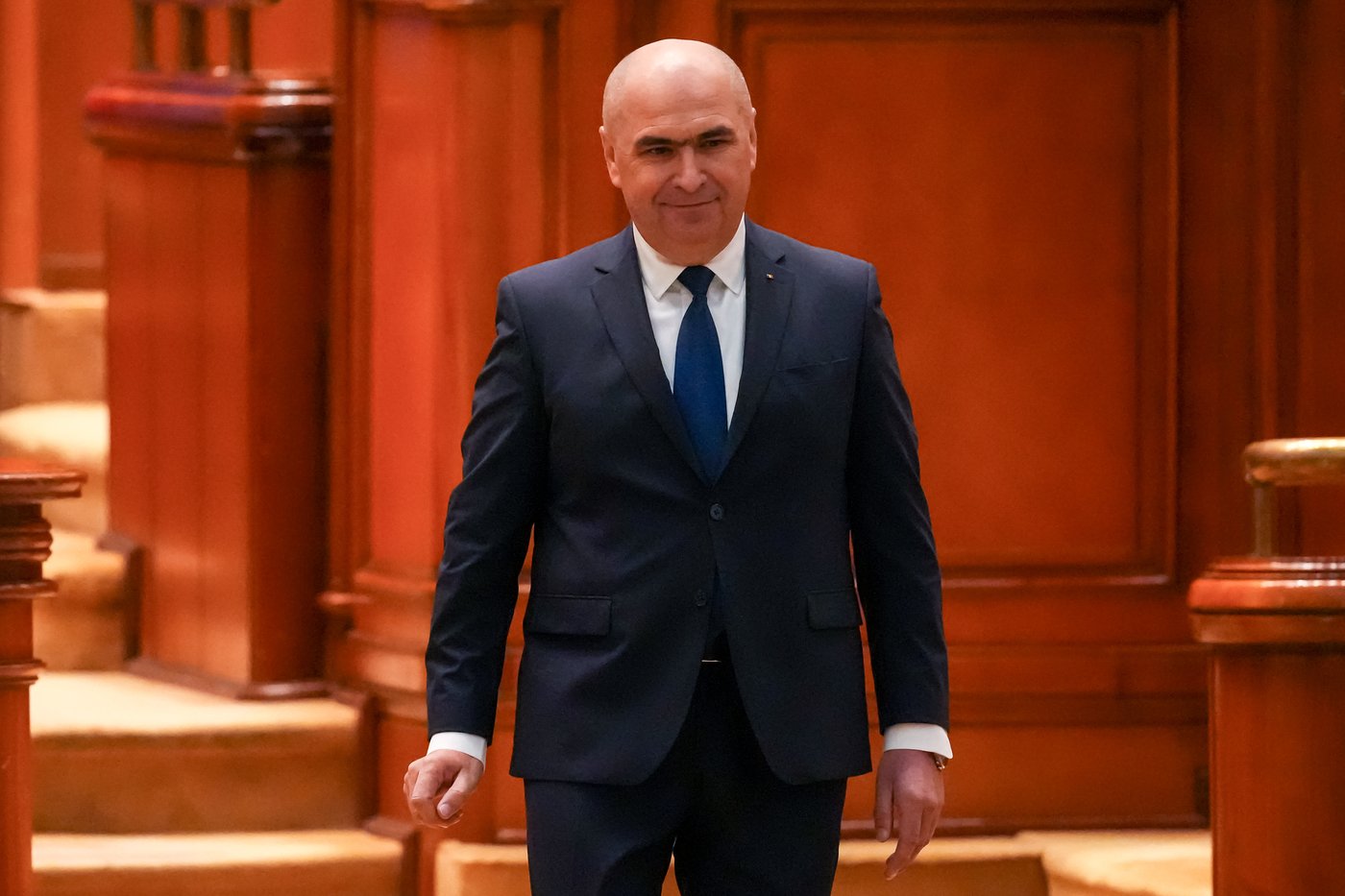 Romanian Prime Minister Ilie Bolojan arrives at a parliament session ahead of a no confidence vote in Bucharest, Romania, Tuesday, May 5, 2026. (AP Photo/Vadim Ghirda)