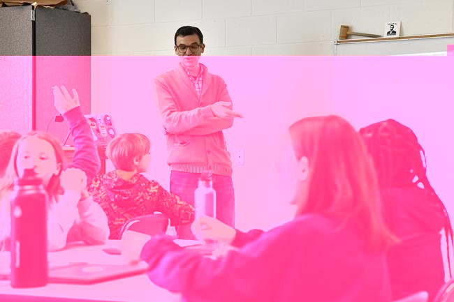 Teacher Donnie Piercey goes over the results of a writing assignment called "Find the Bot" during his class at Stonewall Elementary in Lexington, Ky., Monday, Feb. 6, 2023. The students each summarized a text about boxing champion and Kentucky icon Muhammad Ali then tried to figure out which summaries were penned by classmates and which was written by the chatbot. The chatbot was the new artificial intelligence tool ChatGPT, which can generate everything from essays and haikus to term papers in a matter of seconds. (AP Photo/Timothy D. Easley)