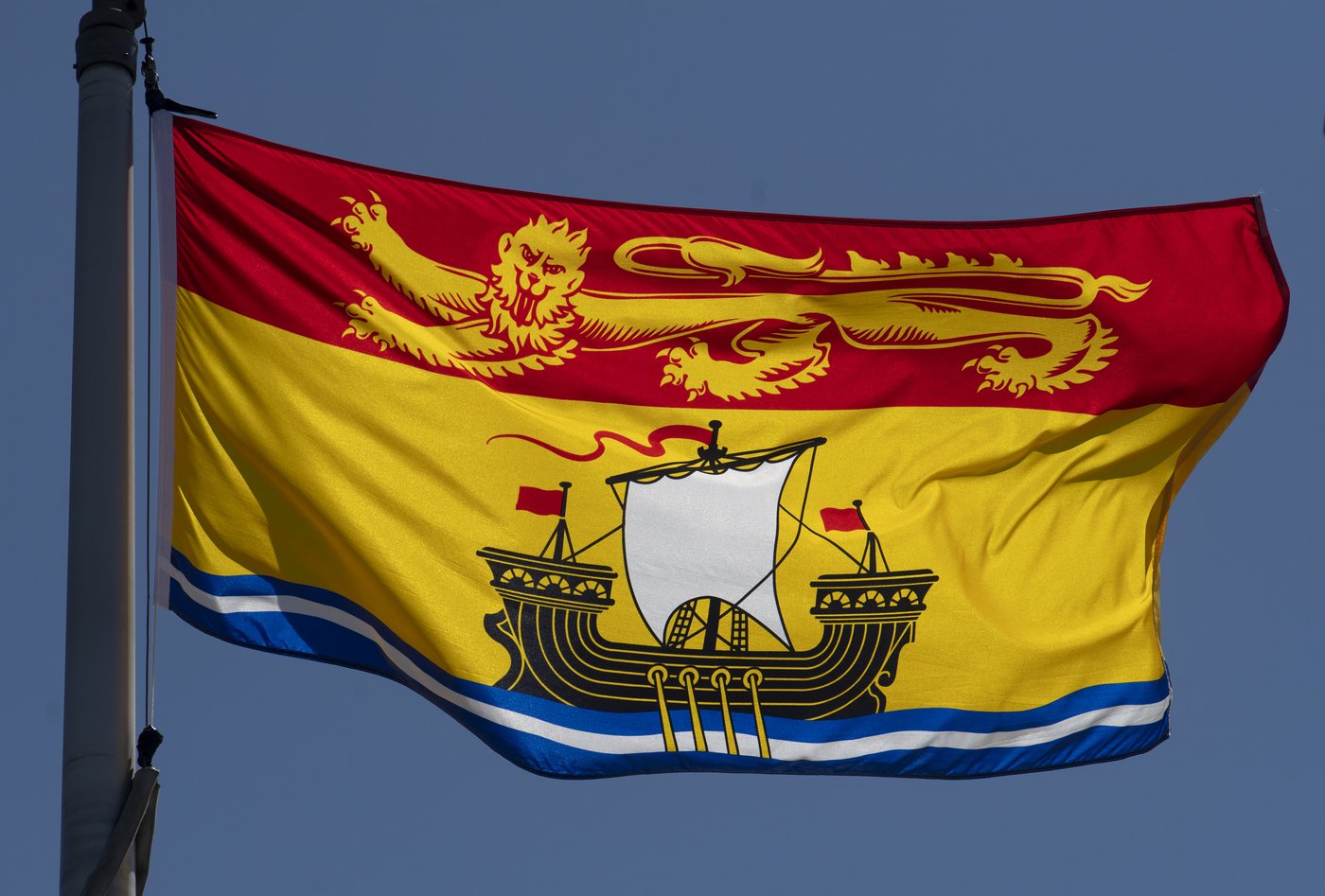 New Brunswick's provincial flag flies on a flagpole in Ottawa, on Monday, July 6, 2020. THE CANADIAN PRESS/Adrian Wyld