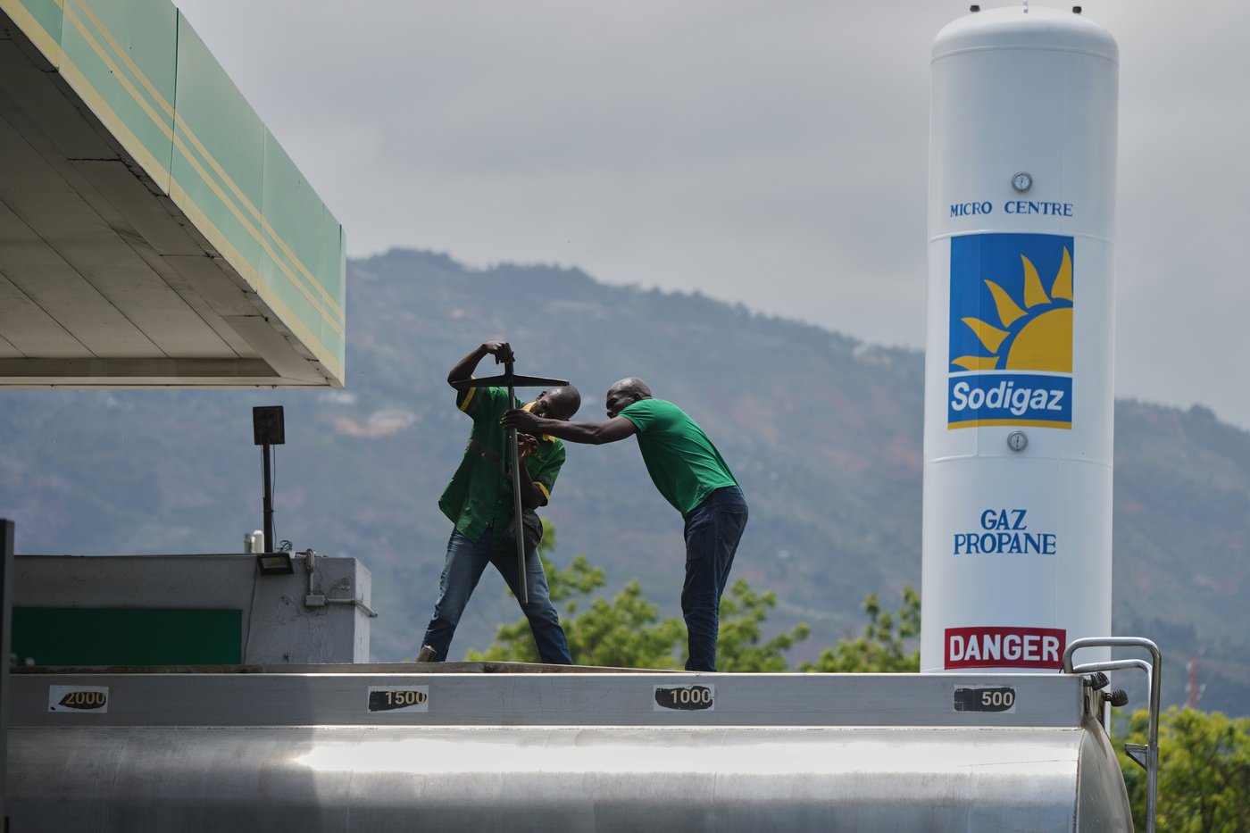 Gas station employees prepare to fill a tank with gas in Port-au-Prince, Haiti, Tuesday, April 7, 2026. (AP Photo/Odelyn Joseph)