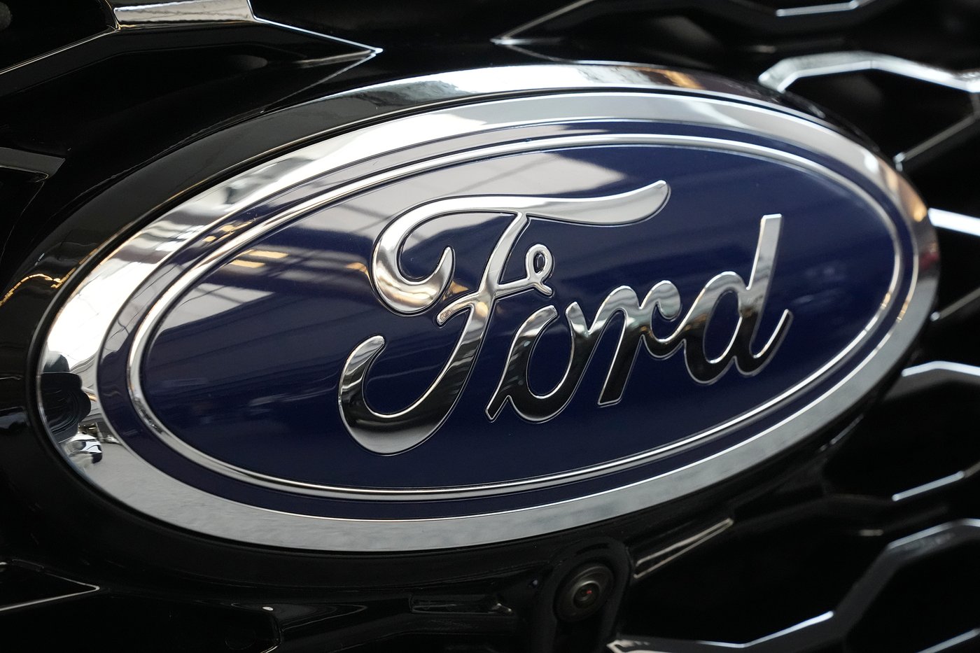 FILE - The Ford logo is seen on the grill of a Ford Explorer on display at the Pittsburgh International Auto Show, in Pittsburgh, on Feb. 15, 2024. (AP Photo/Gene J. Puskar, File)
