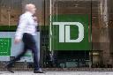 A person makes their way past a Toronto-Dominion Bank in the Financial District of Toronto, Monday, Aug. 14, 2023. THE CANADIAN PRESS/Spencer Colby