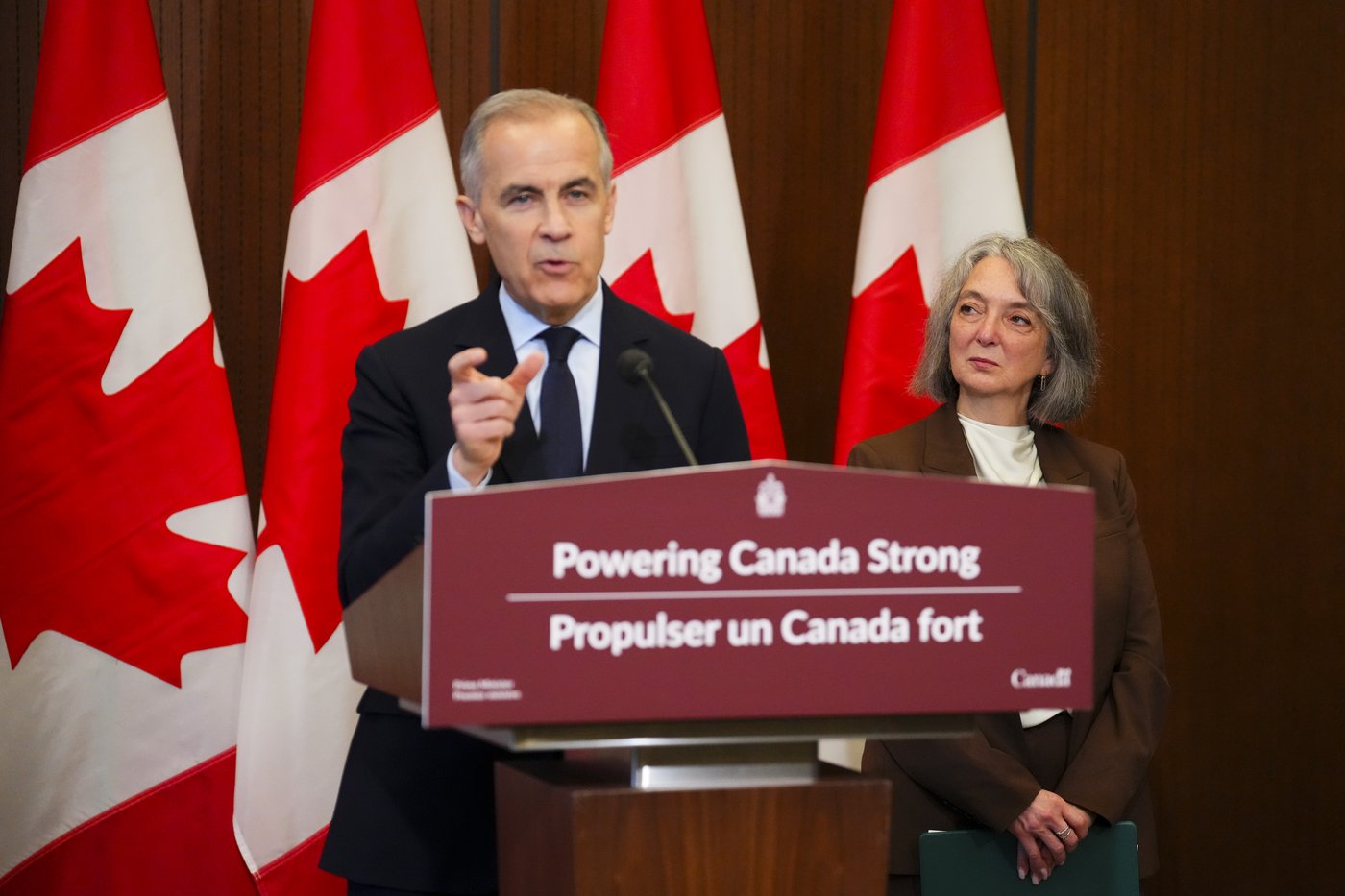 Prime Minister Mark Carney makes an announcement alongside Minister of Environment and Climate Change Julie Dabrusin, right, on Parliament Hill in Ottawa on Thursday, May 14, 2026. THE CANADIAN PRESS/Sean Kilpatrick