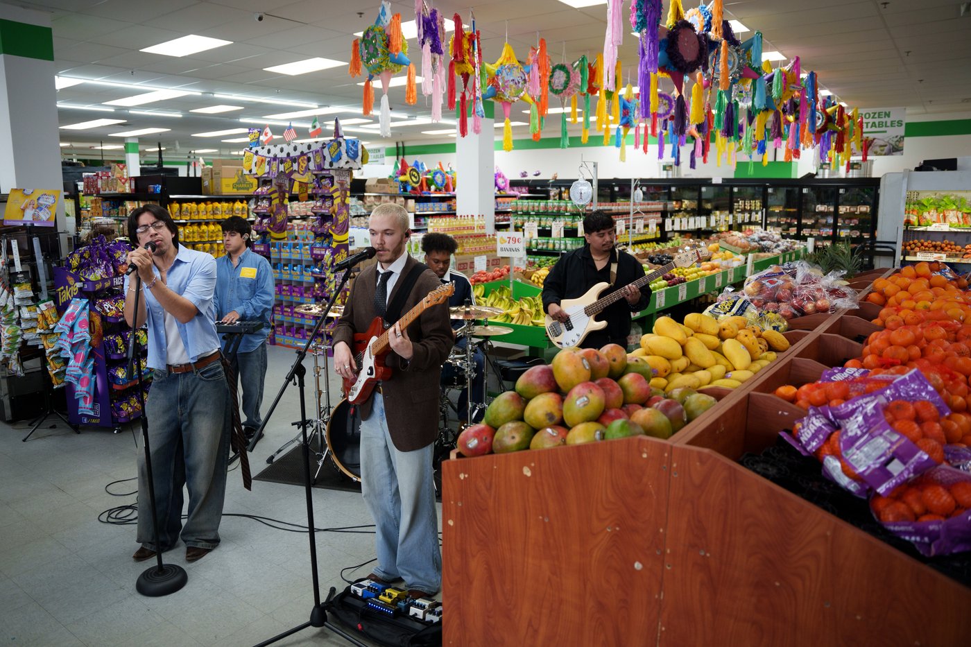 Bilingual alternative pop band Luna Luna performs in the produce section of Fiesta Fresh Market in New Castle, Del., on Sunday, April 26, 2026. (AP Photo/Mingson Lau)