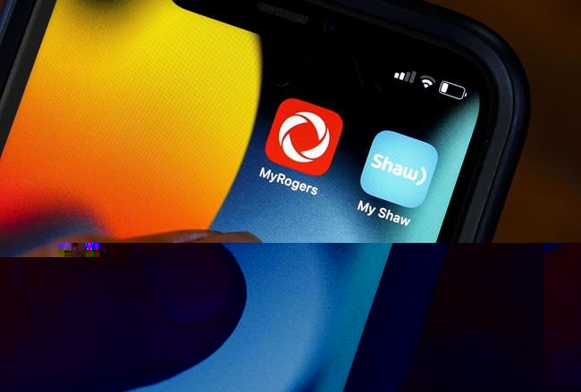 Rogers and Shaw applications are pictured on a cellphone in Ottawa on Monday, May 9, 2022. Rogers Communications Inc. is relocating around 300 Shaw call centre jobs based overseas to Canada. THE&nbsp;CANADIAN PRESS/Sean Kilpatrick