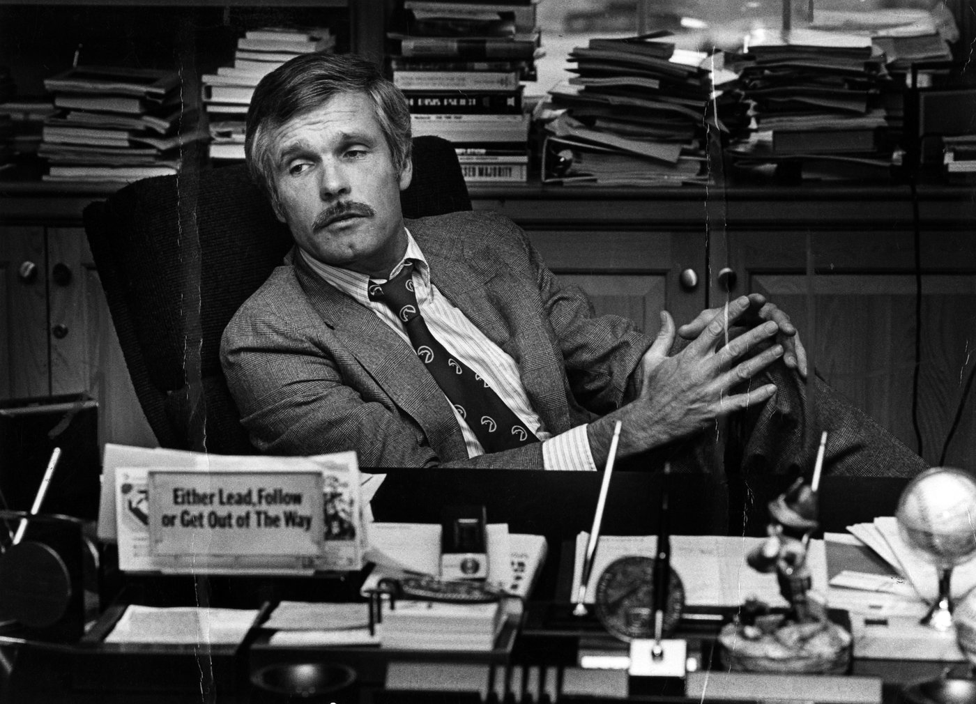 FILE - Ted Turner is seen at his desk inside the CNN Center in 1982. (Nancy Mangiafico/Atlanta Journal-Constitution via AP, File)